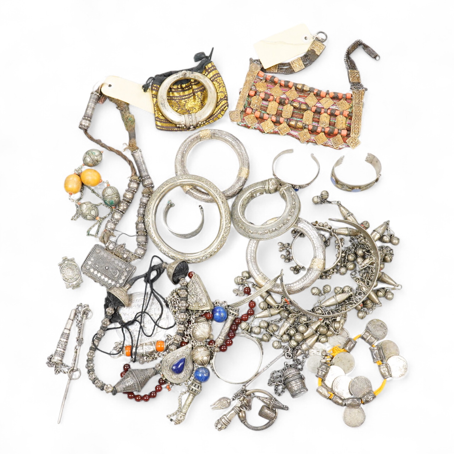 A collection of Bedouin white metal, gilt metal, lapis lazuli mounted jewellery, etc. from Oman